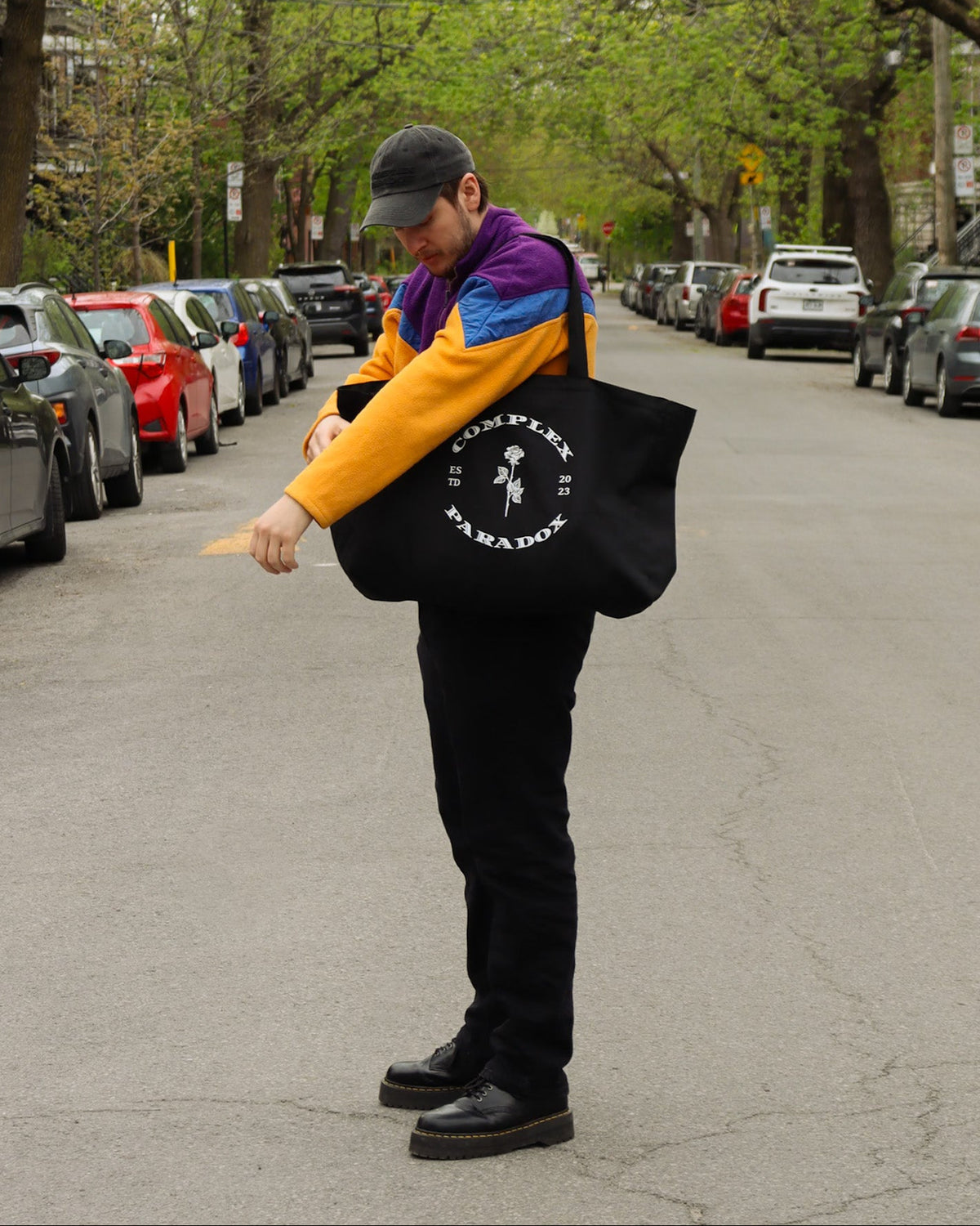 Complex Paradox rose logo tote bag worn on the street, CMPLX timeless streetwear piece